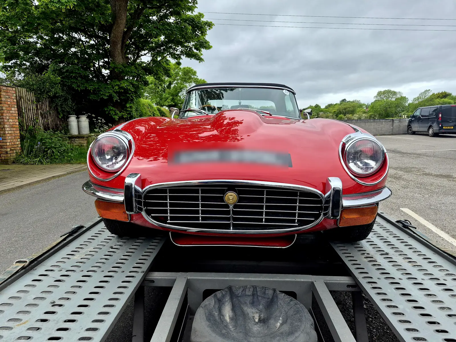 Red Jaguar E-Type strapped down on a WS Logistics open transporter, classic car transport in Lancashire
