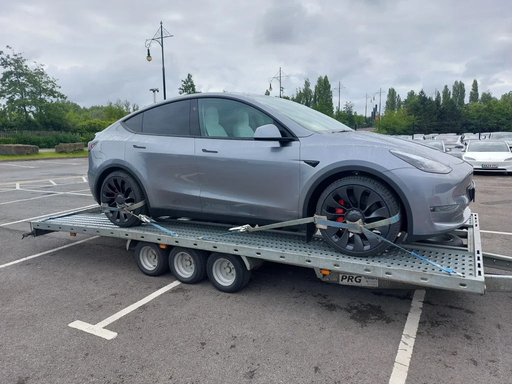 Grey Tesla Model Y on WS Logistics transporter, EV delivery North West