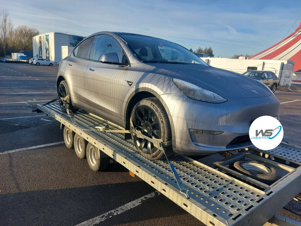WS Logistics branded transporter carrying a Tesla Model Y, vehicle transport across Lancashire and the North West