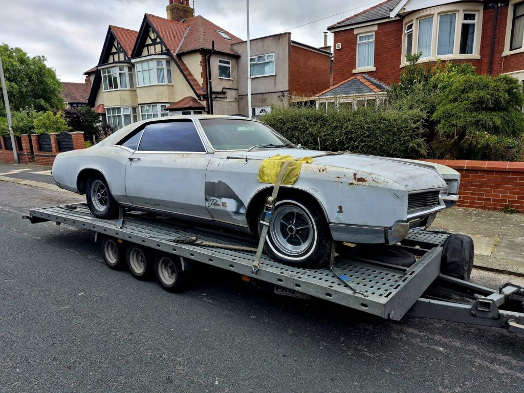 Buick Riviera restoration project, a non-runner that rolls and steers, strapped down for recovery in Blackpool
