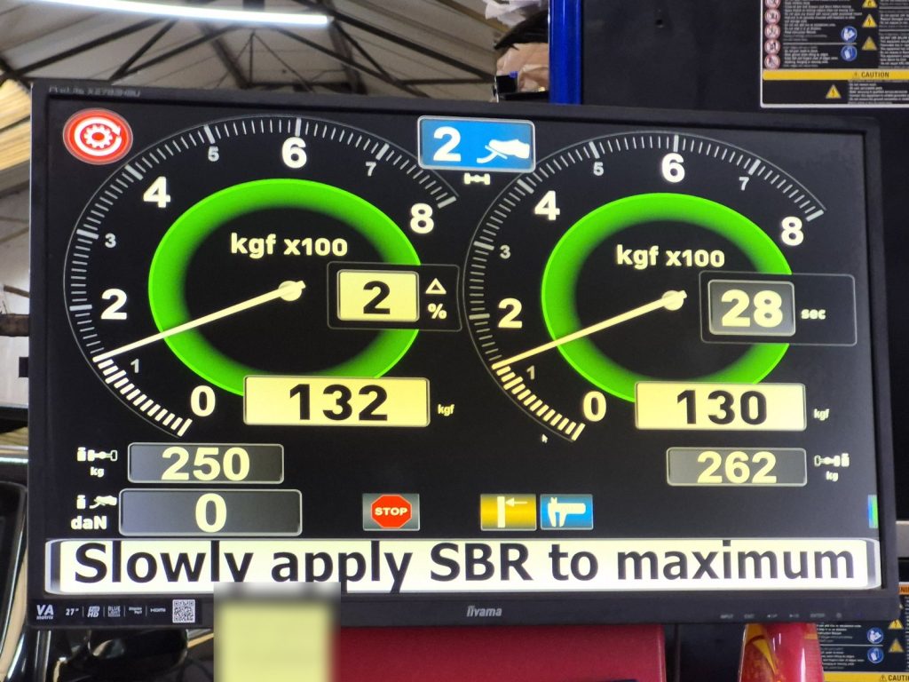 Roller brake tester readout during an MOT test at a garage MOT bay