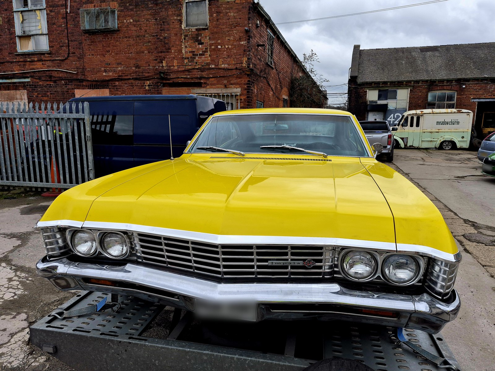 Yellow 1967 Chevrolet Impala on the WS Logistics trailer for classic car transport