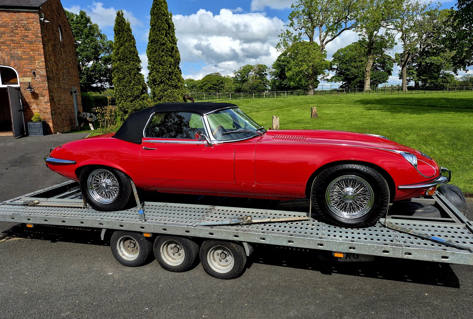 Red Jaguar E-Type loaded on the WS Logistics open trailer for classic car transport in Lancashire